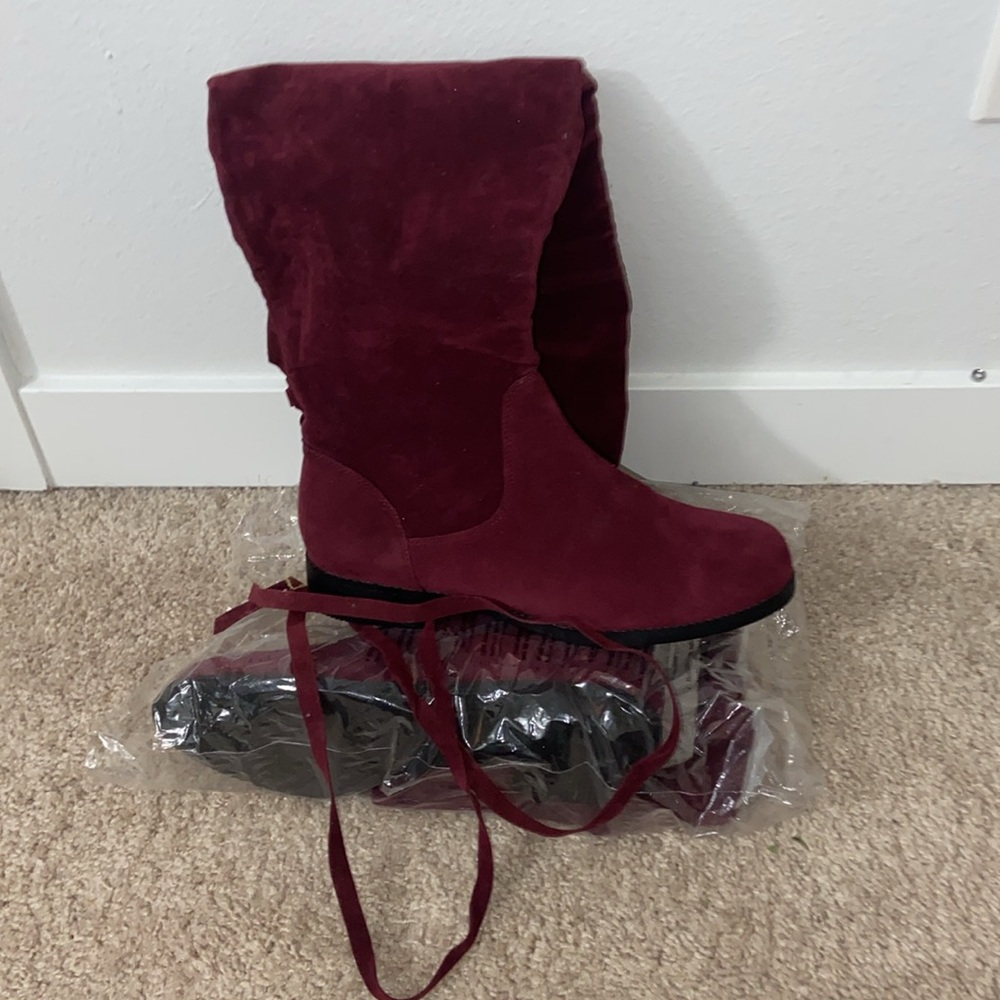 Red knee high tie off velvet boots with black bottoms